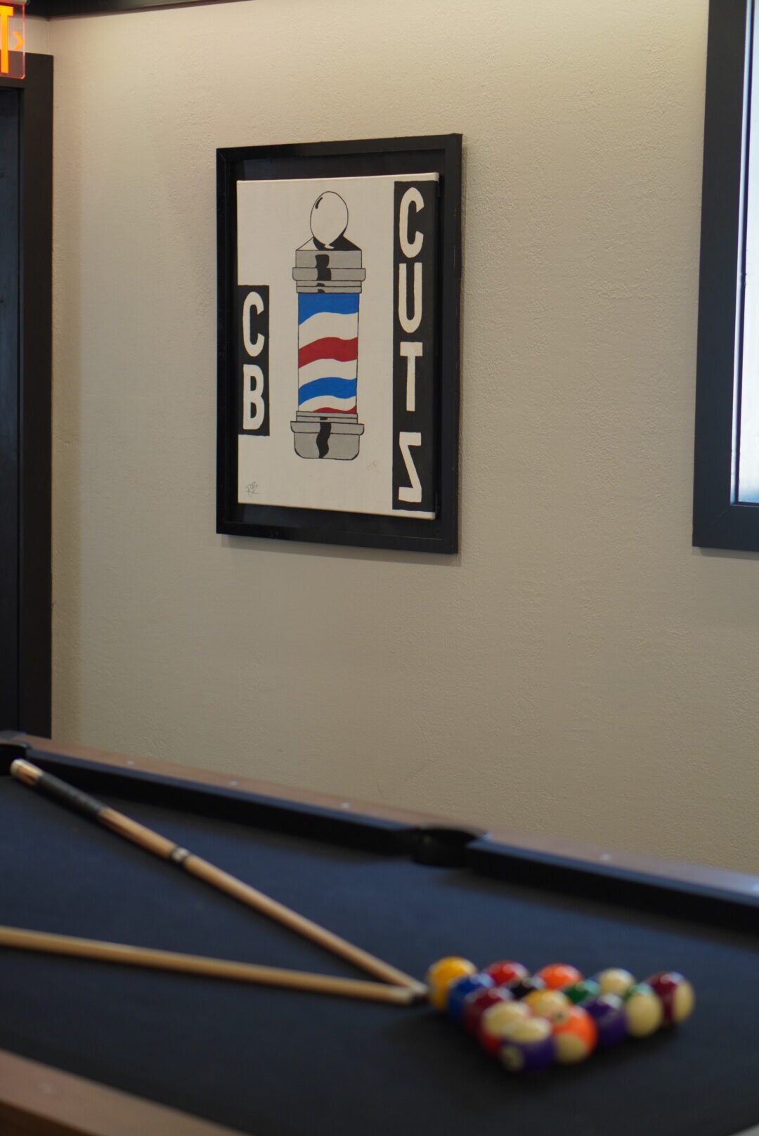 Barber pole print on the shop wall